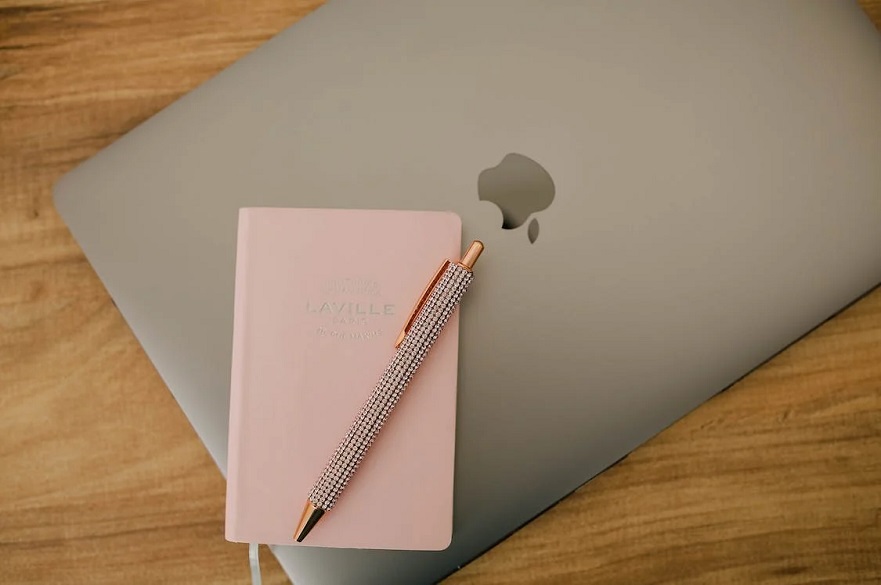 Notebook and a Pen on a Laptop